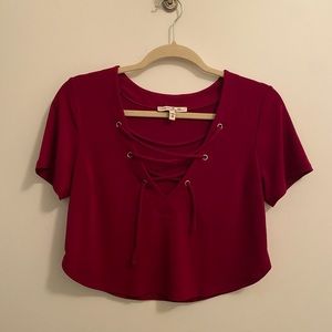 Dark raspberry cropped top. Loose fit laced detail.